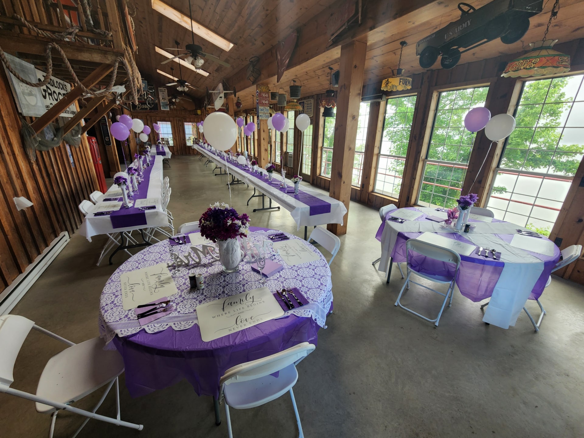 An elegant arrangement of tables and chairs in the glass room at RiverBarn, overlooking the picturesque Ohio River. The modern setup exudes sophistication and provides a perfect setting for memorable events.