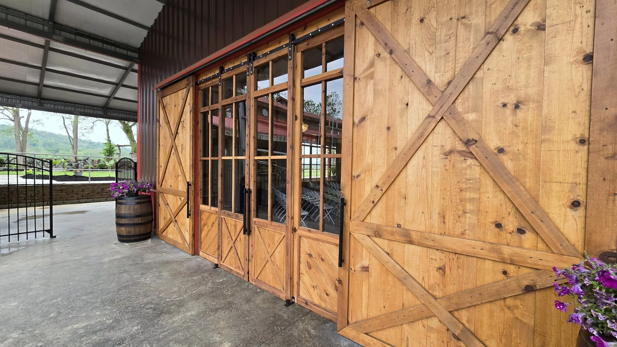 Covered RiverBarn entrance with wooden doors and outdoor view