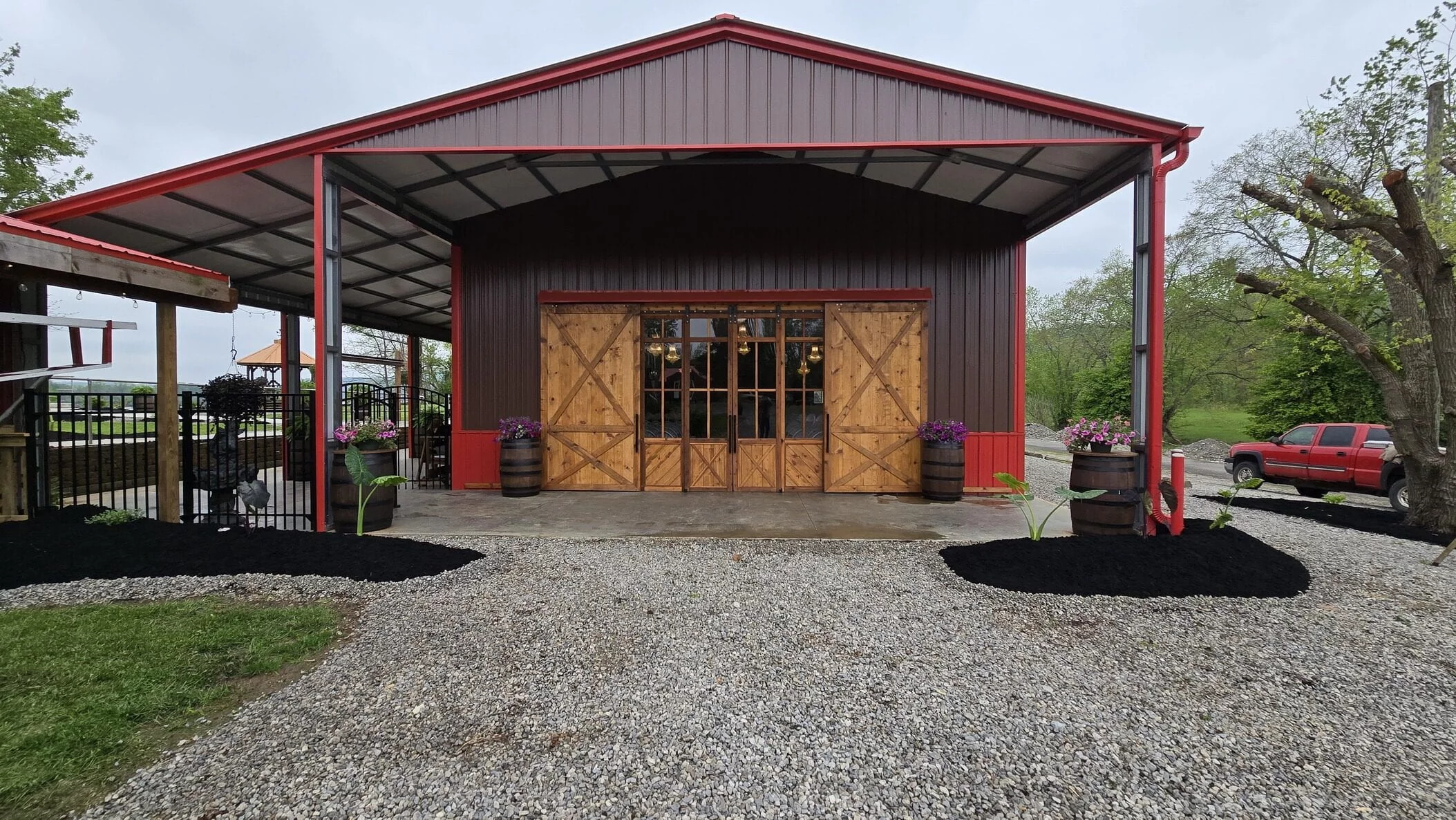 Entrance to The RiverBarn Event Center with covered arrival area and barn doors