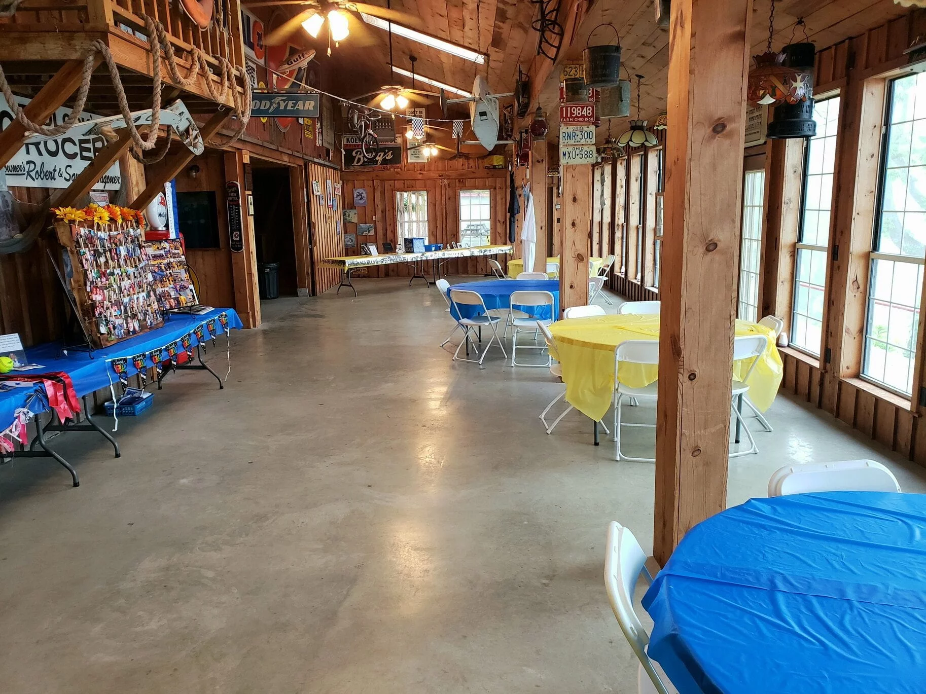 Tables and chairs arranged for a casual private event inside The RiverBarn
