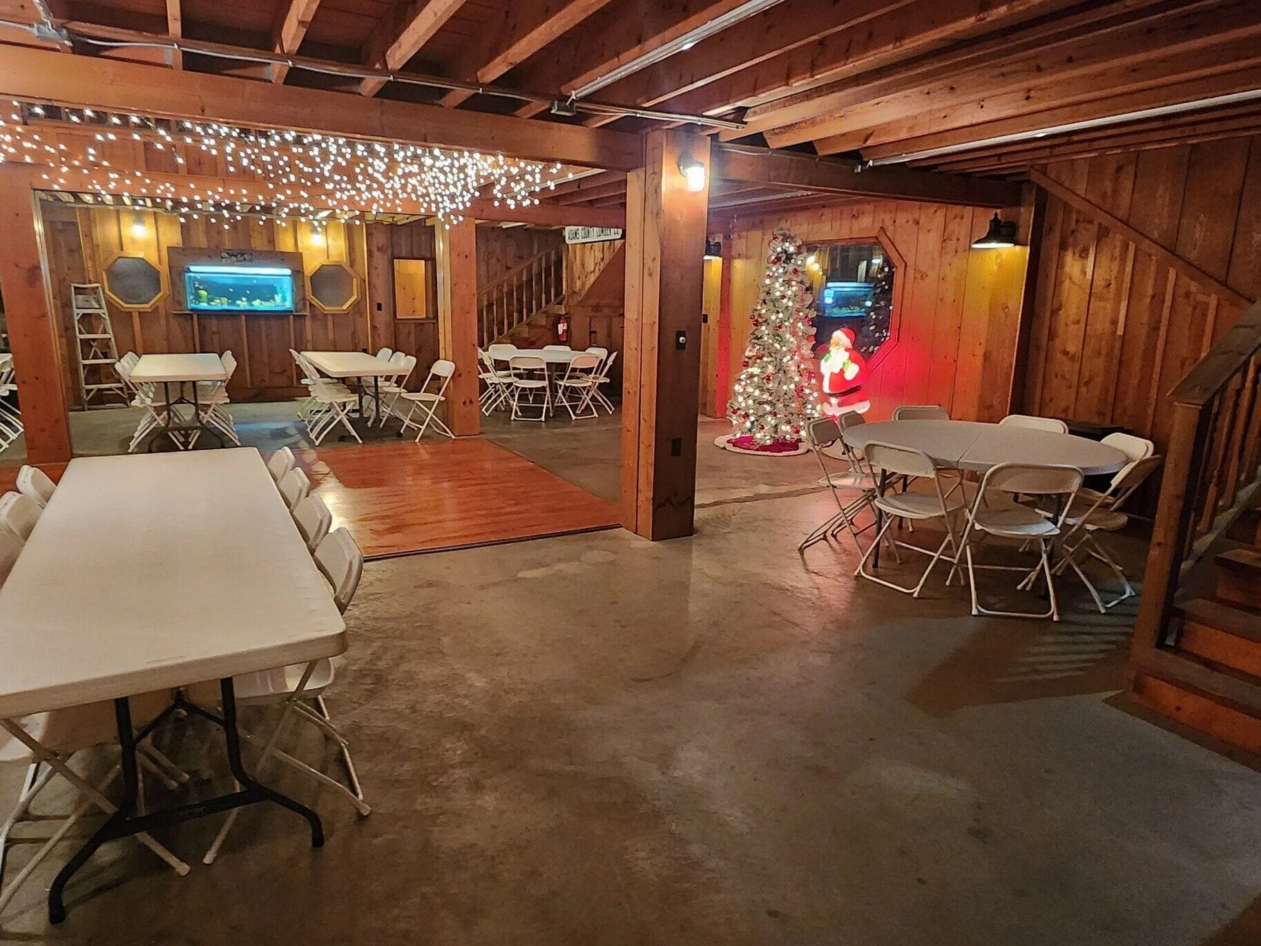 Interior tables arranged under warm lights for an event at The RiverBarn