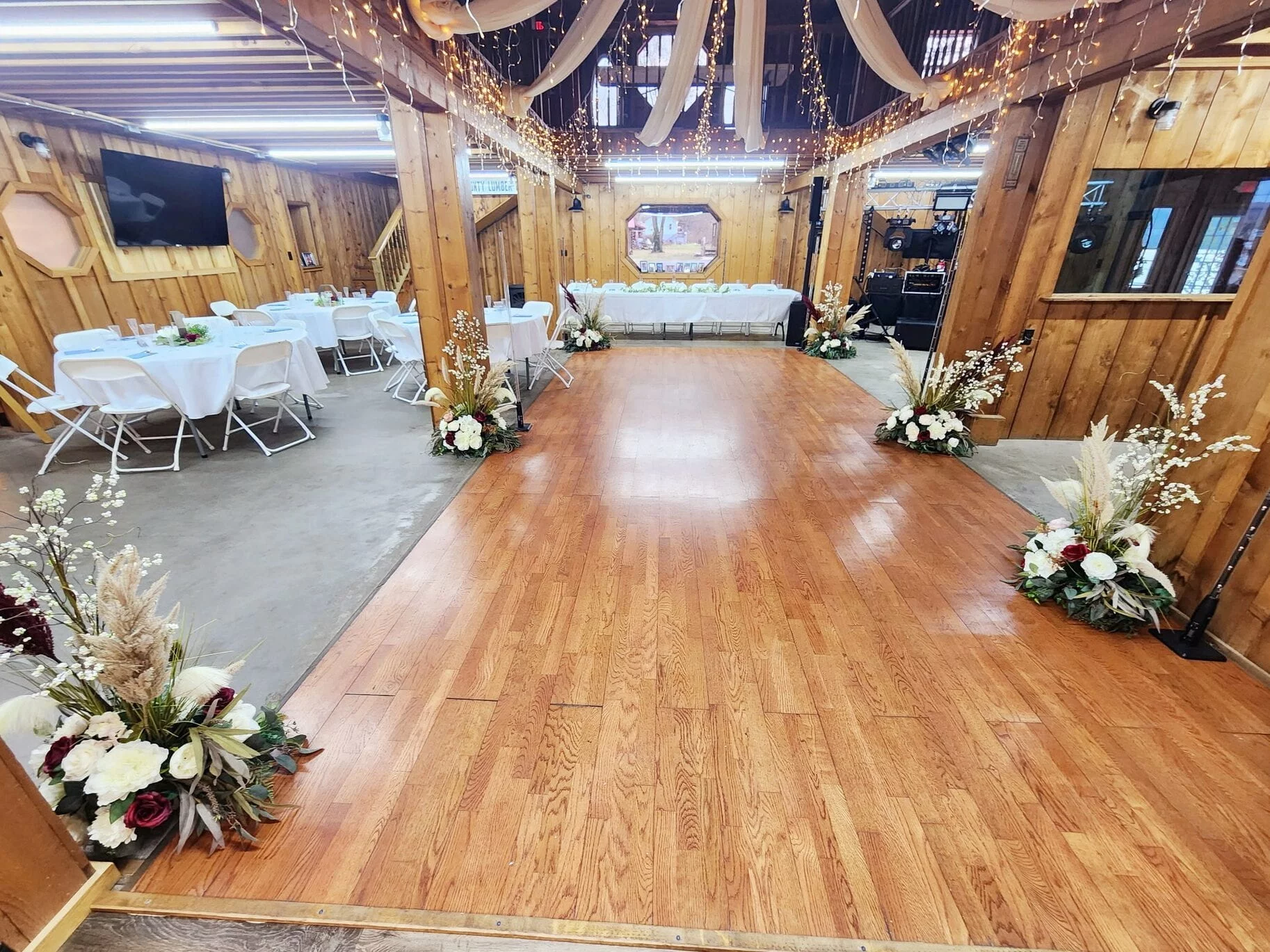 The RiverBarn interior arranged for a private event with tables and dance floor