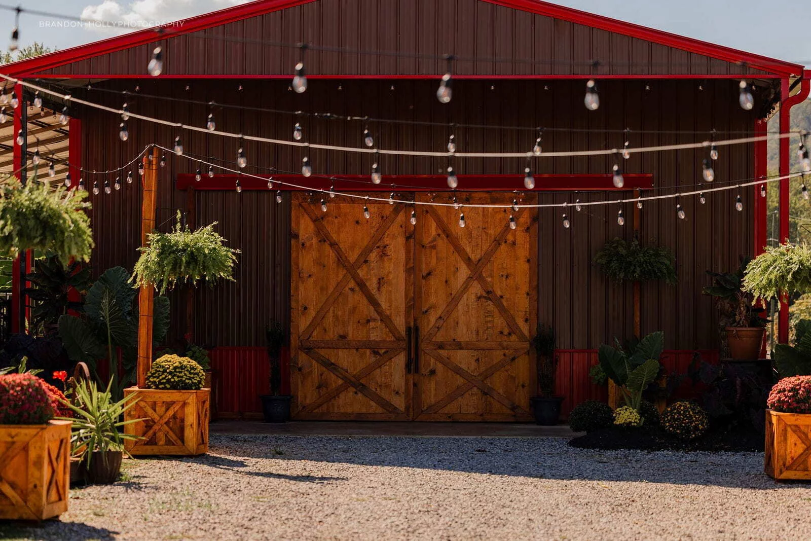 The RiverBarn Event Center exterior with string lights and barn doors in Manchester Ohio