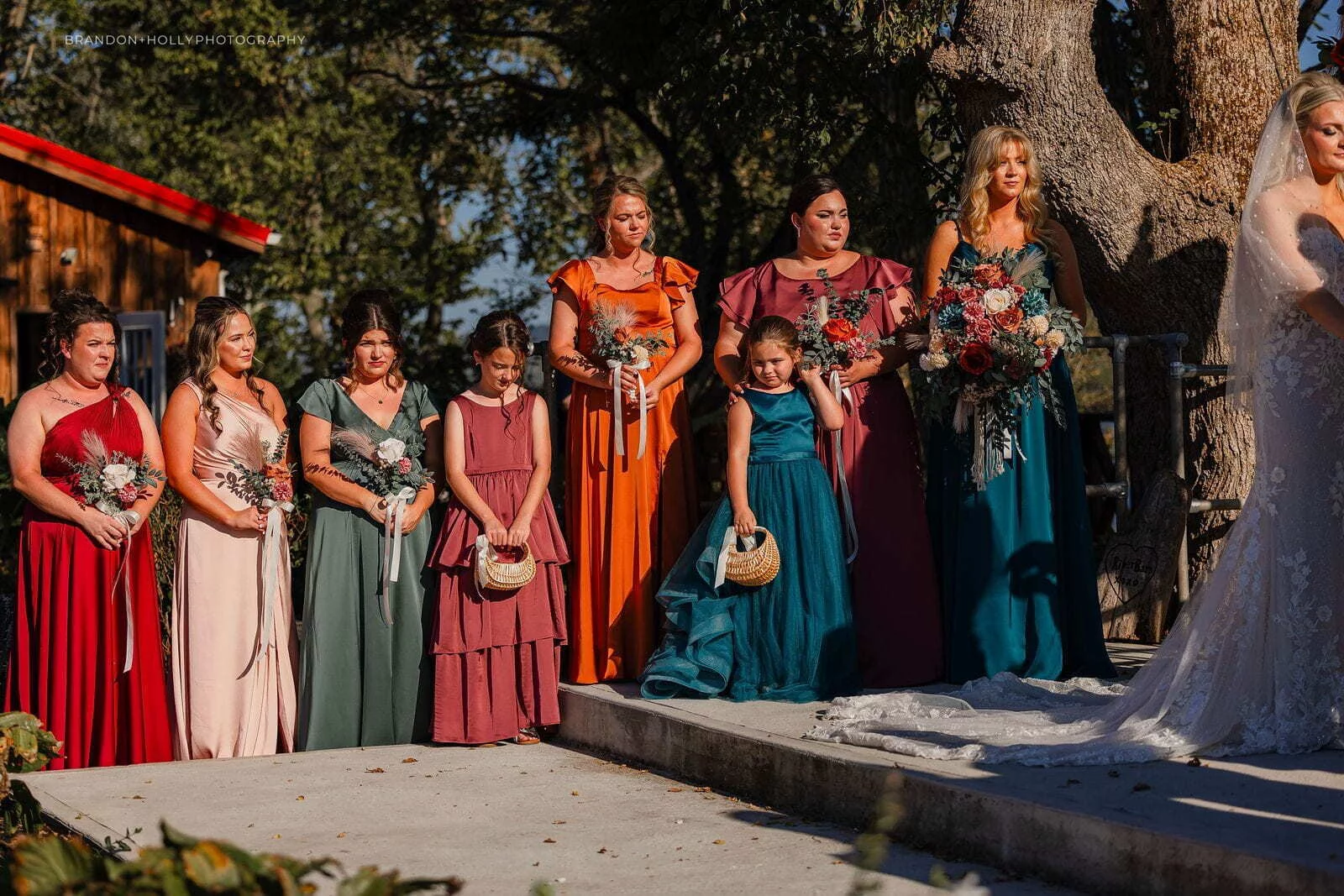 Wedding party standing in the outdoor ceremony area at The RiverBarn